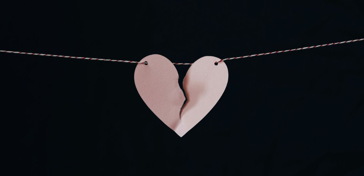 paper heart on a string torn in half